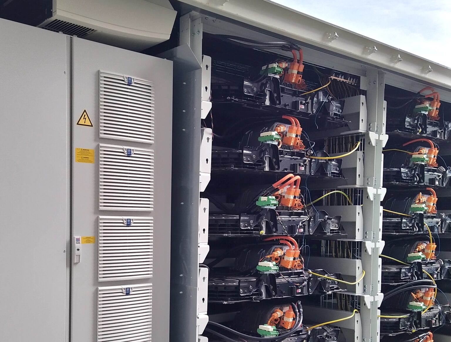 Automotive high-voltage batteries installed in a storage cabinet